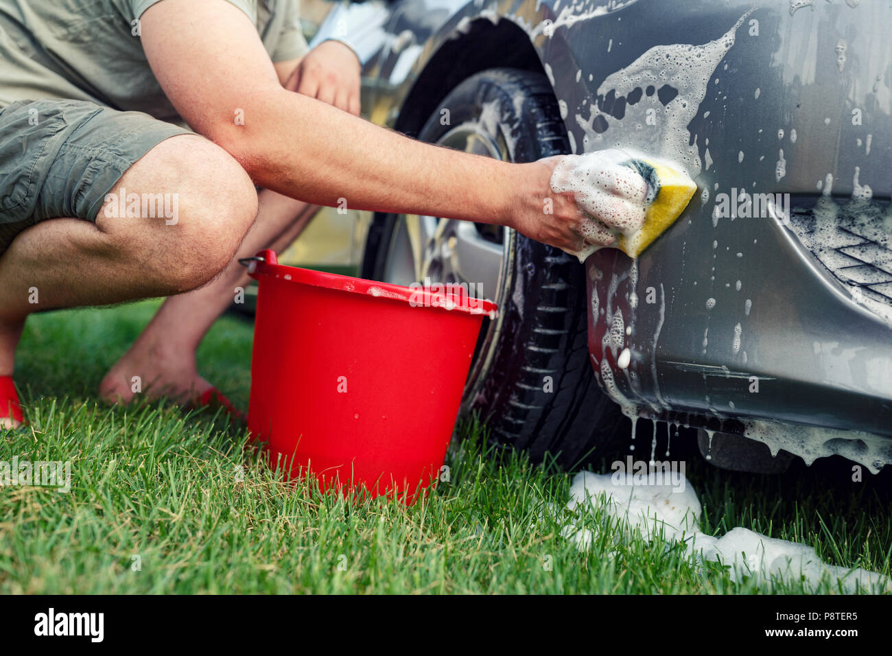 Schwamm und Eimer - junge Männer sein Auto waschen Stockfotografie - Alamy