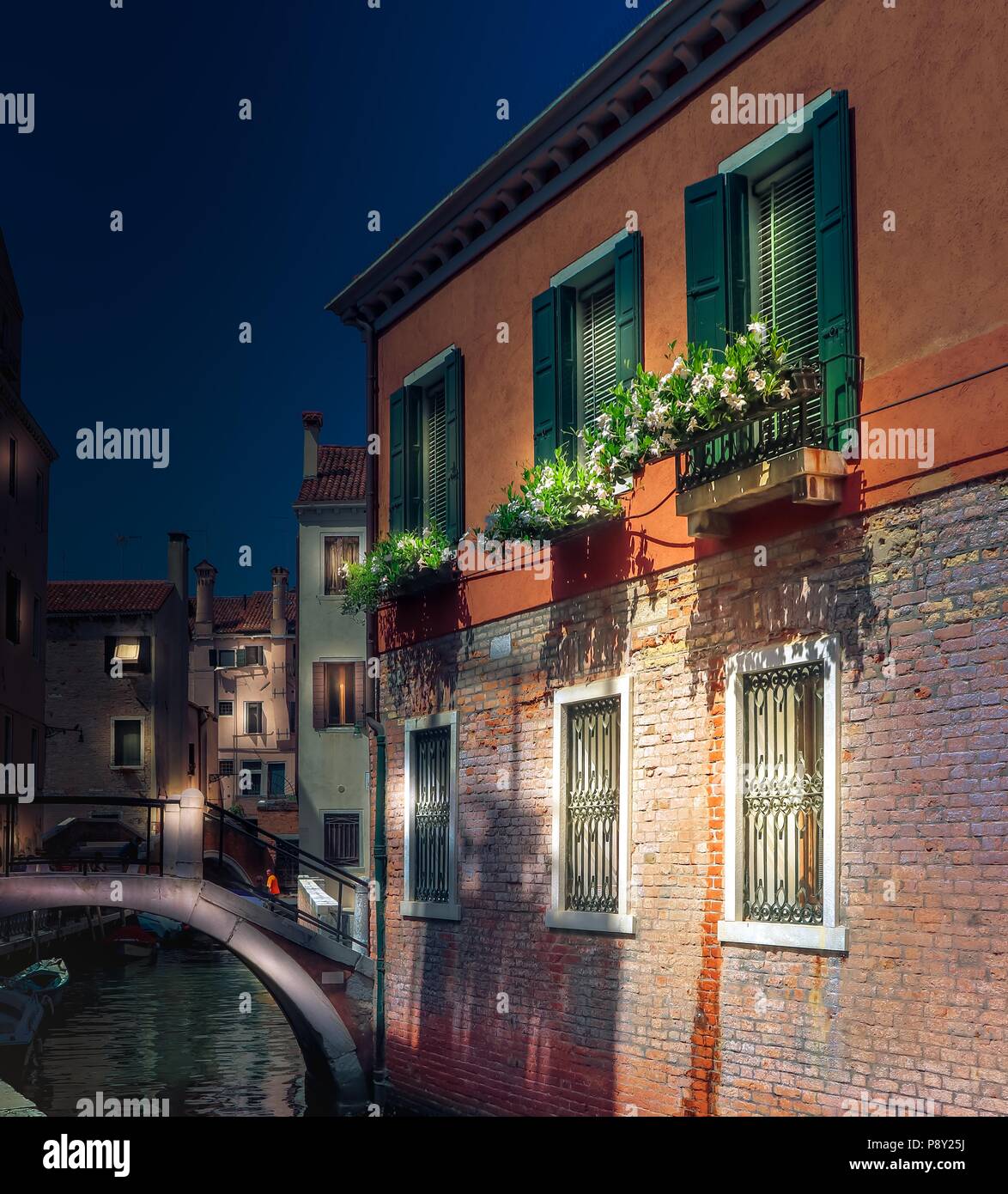 Venedig Nacht romantische Aussicht mit Backstein Haus und die kleine Brücke über den Kanal. Italien Stockfoto