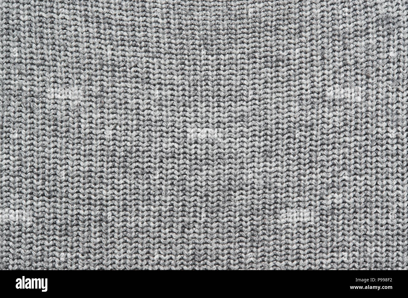 Grauer Strickpullover Textur Hintergrund. Platz für Kopieren, Text, Schrift. Stockfoto