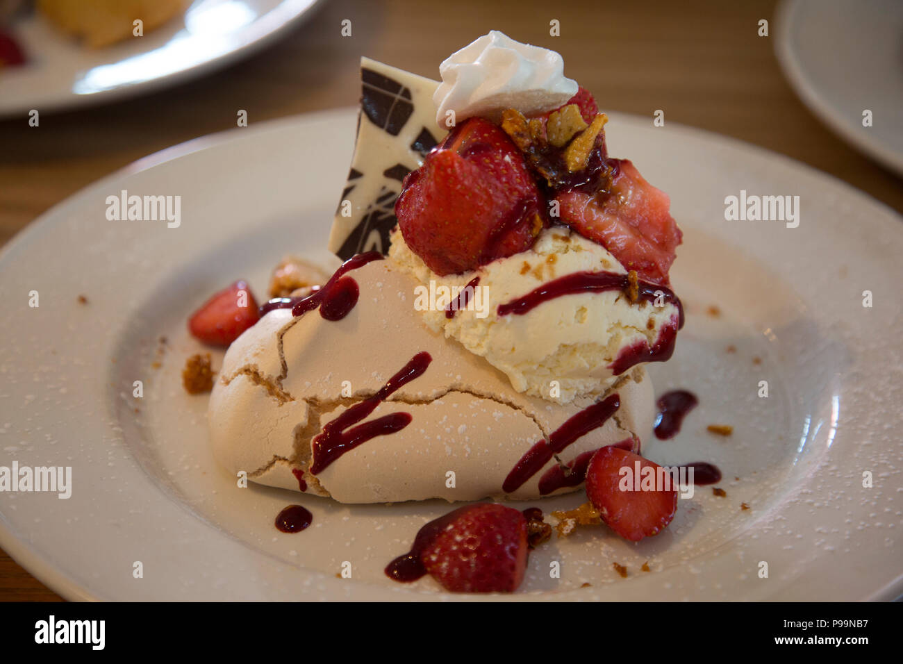 Erdbeeren mit Sahne Baiser fancy Wüste auf weiße Platte Stockfoto