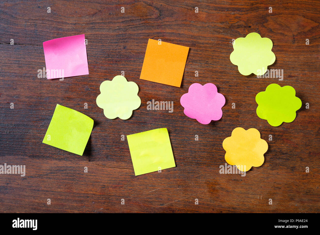 Schule Konzept. Klebrige bunten Noten in verschiedenen Formen mit Kopie Speicherplatz auf Holz- Hintergrund. Stockfoto