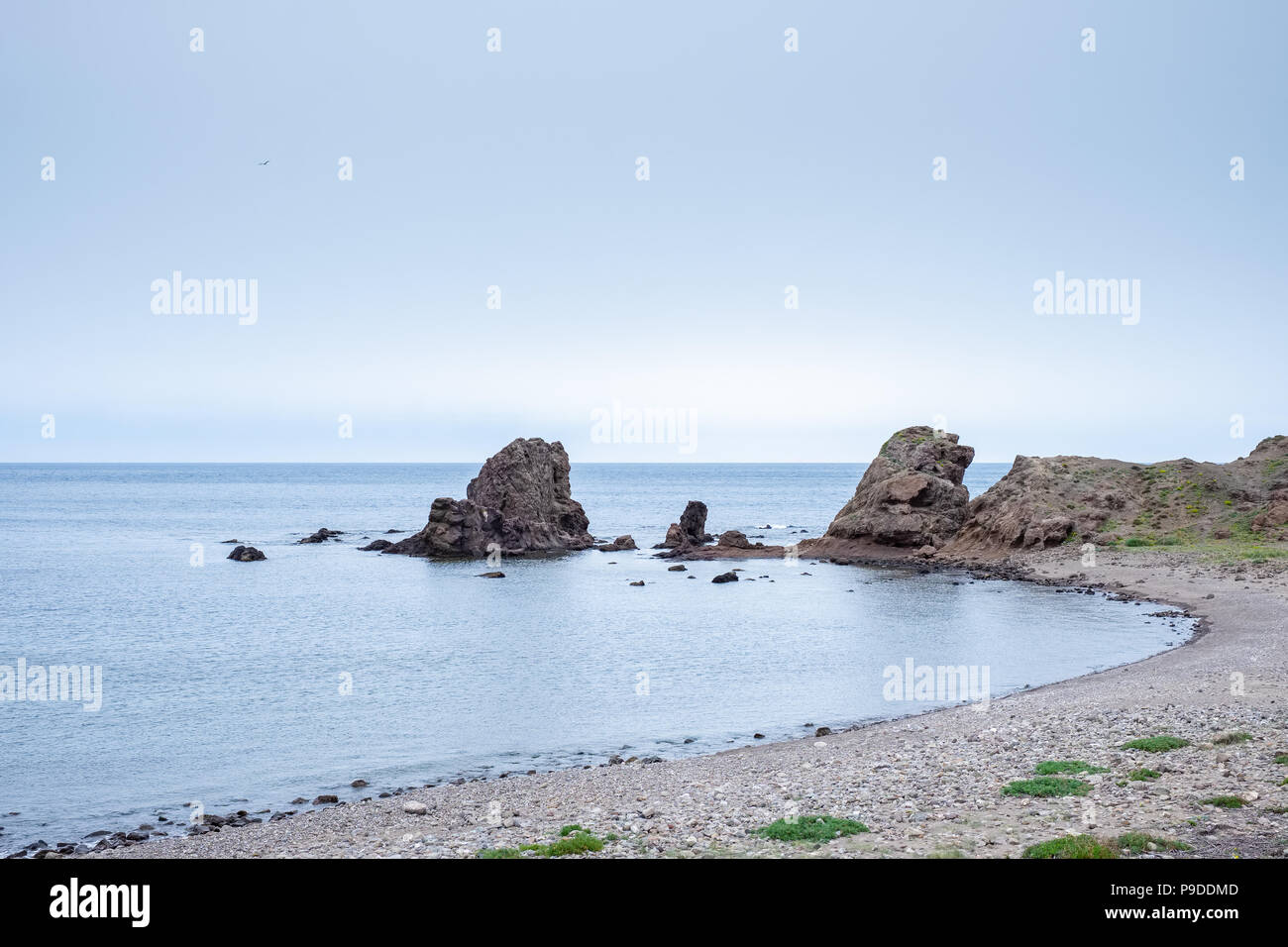 Strand mit Felsen im Hintergrund Los Escullos, an einem bewölkten Tag. Stockfoto