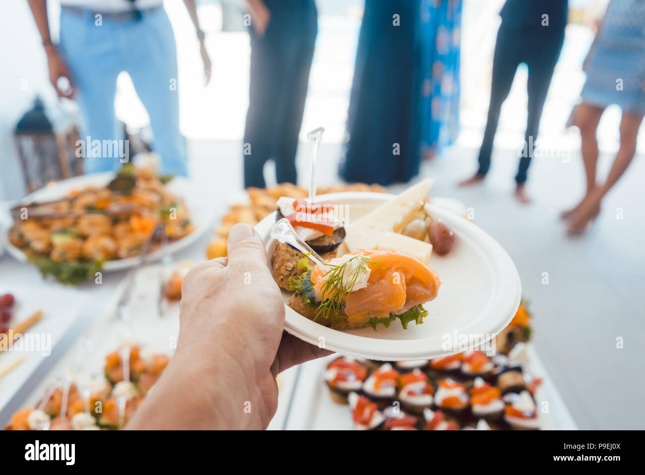 Man hilft sich selbst am Buffet der Party im Freien essen Stockfoto