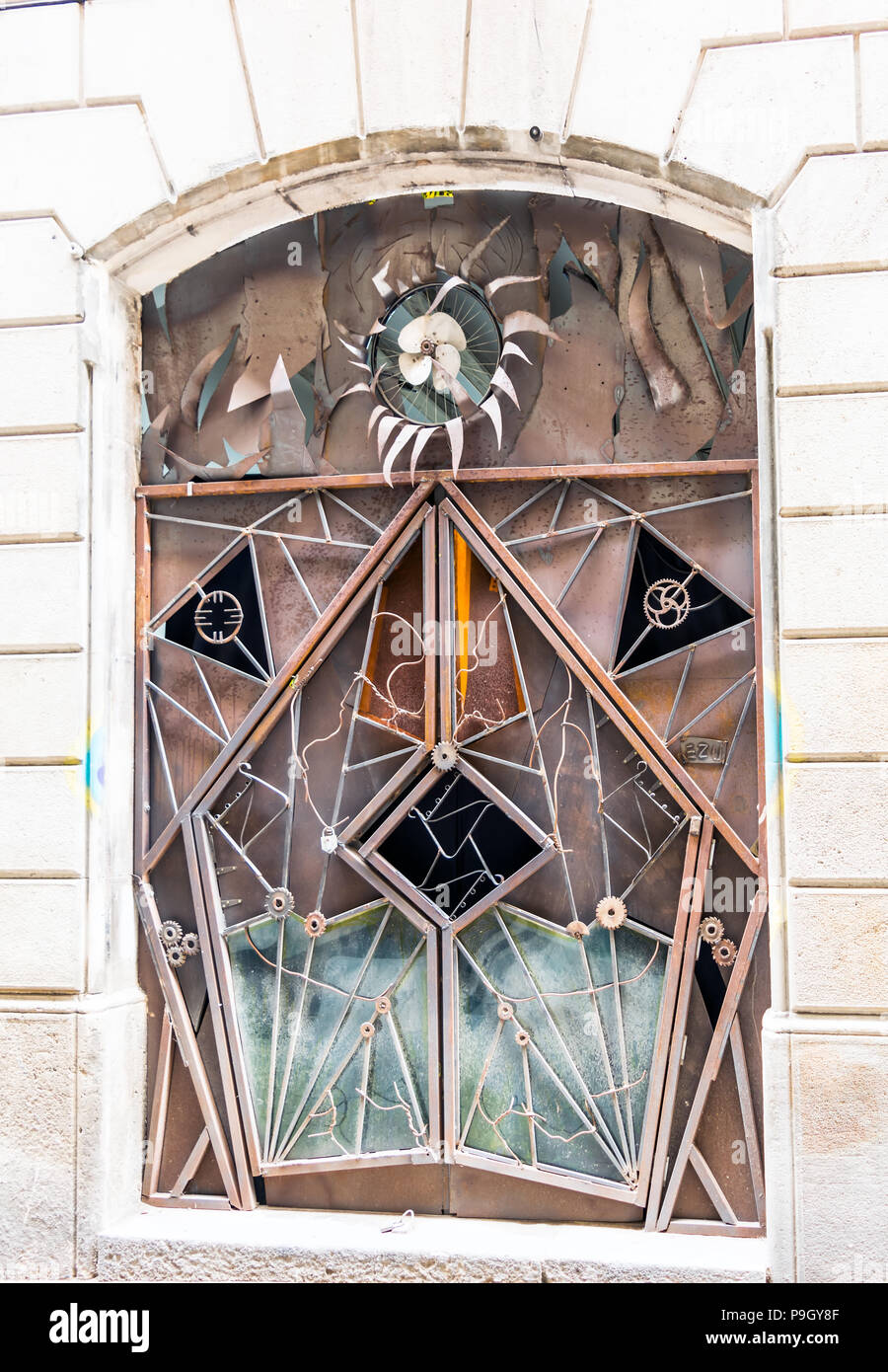 Exzentrische eigentümliche rusty Industrietor mit Getrieben und Lüfterrad Stockfoto