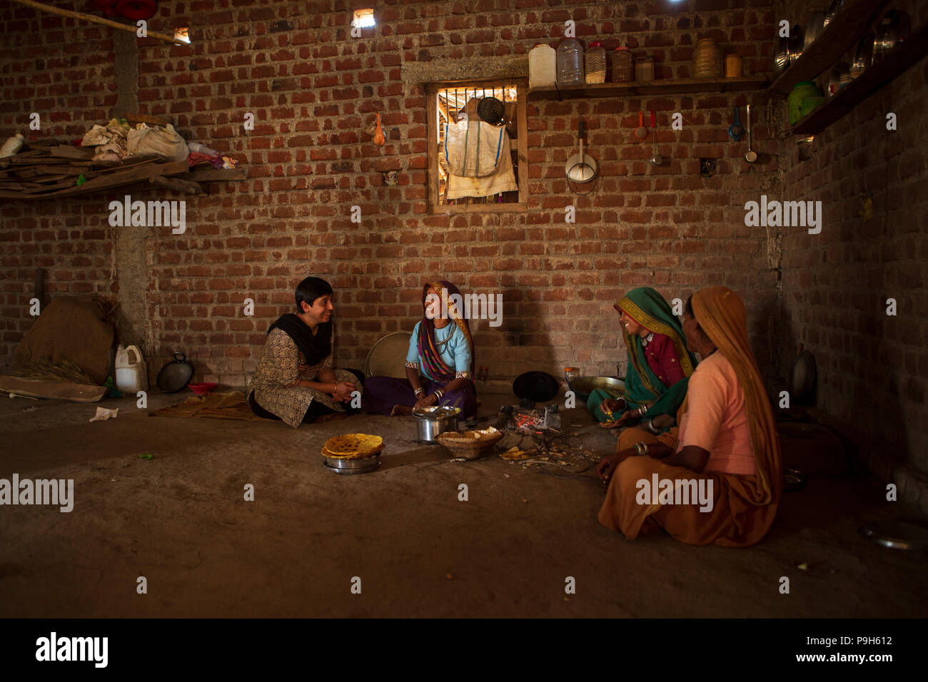 Eine Gruppe von Frauen, die über den ökologischen Landbau in der Küche ihrer Wohnung im ländlichen Indien. Stockfoto