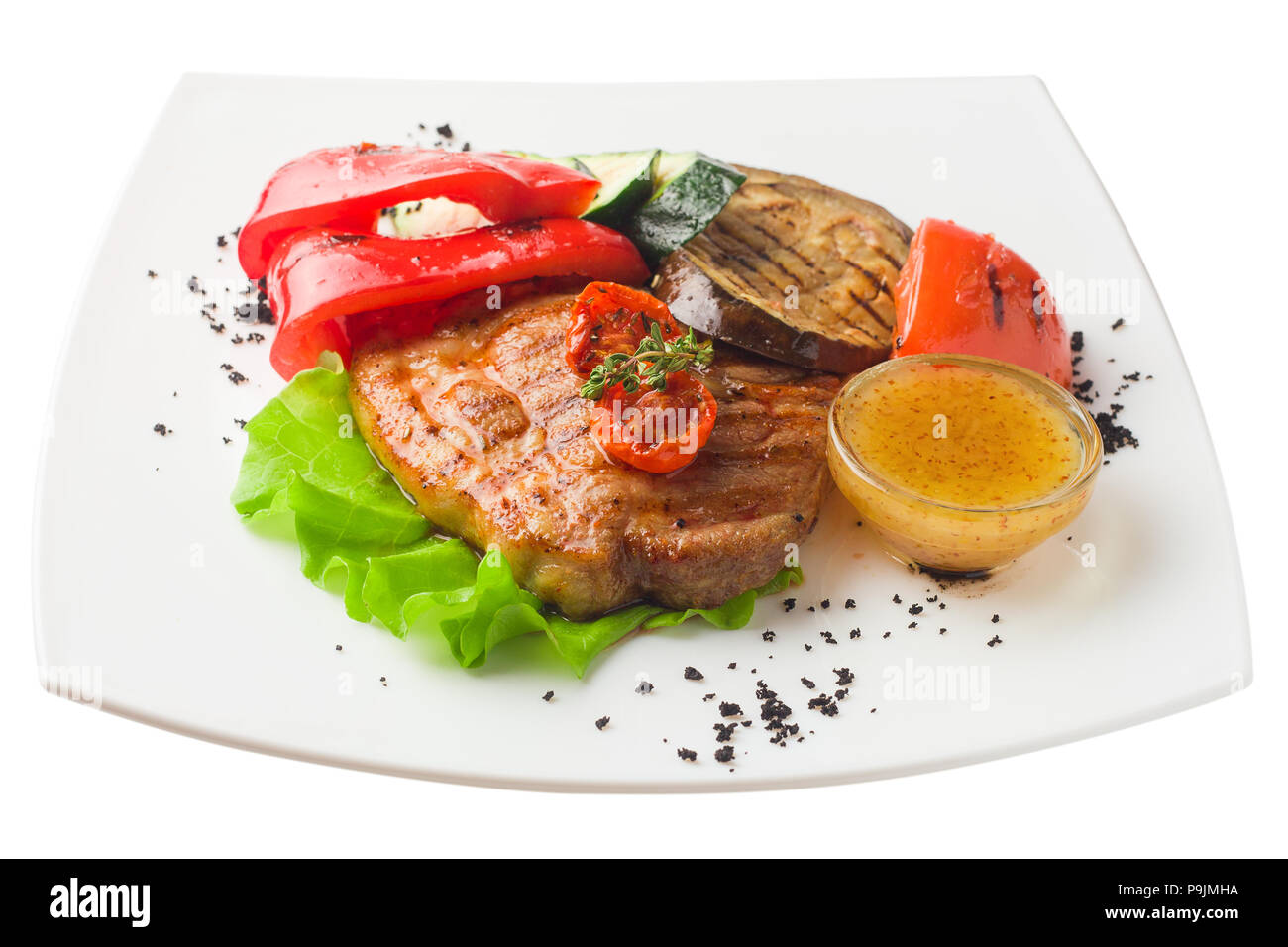 Saftig gegrilltem Schweinefleisch mit Gemüse auf einem weißen Hintergrund, isolat Stockfoto