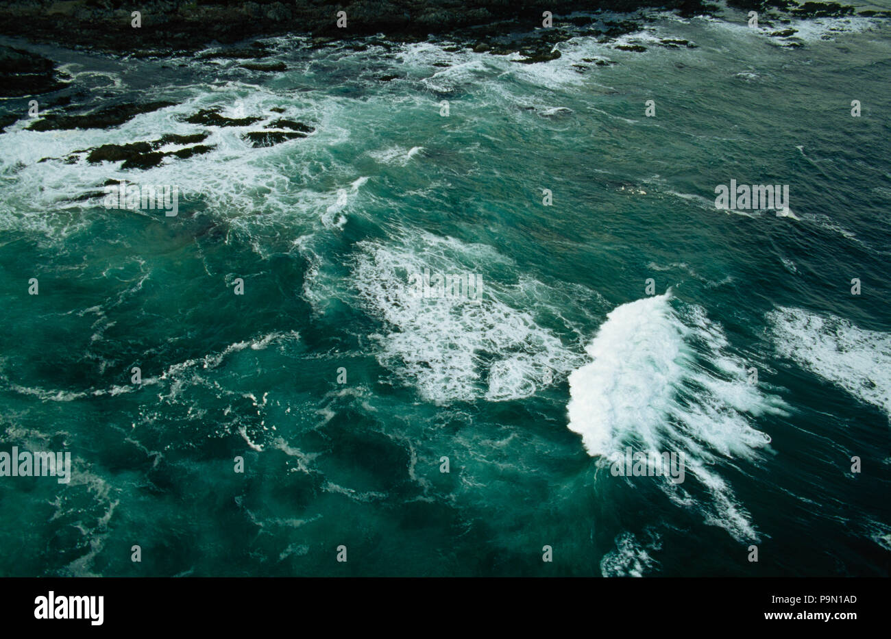 Ein Luftbild der Wellen, die Zerschlagung in einem entfernten Küste. Stockfoto