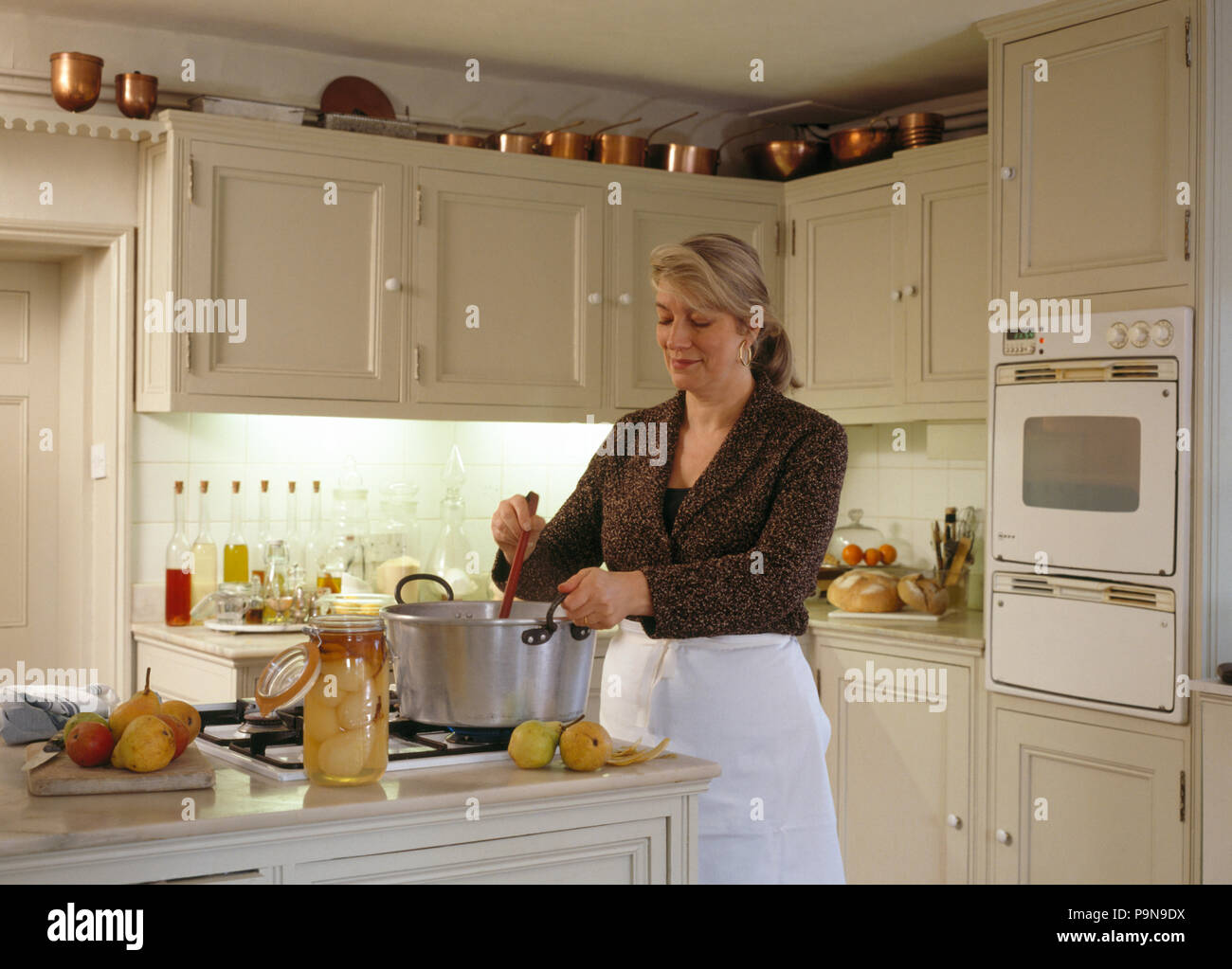 Frau Kochen in einem 90er jahre Küche für redaktionelle NUR VERWENDEN Stockfoto