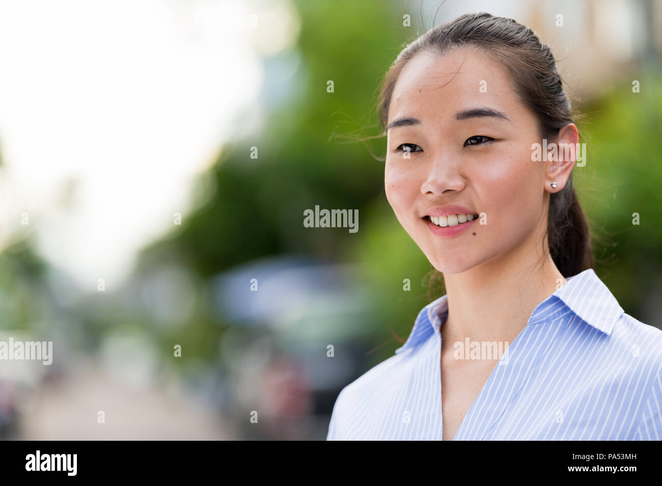 Junge schöne asiatische Geschäftsfrau im Freien Stockfoto