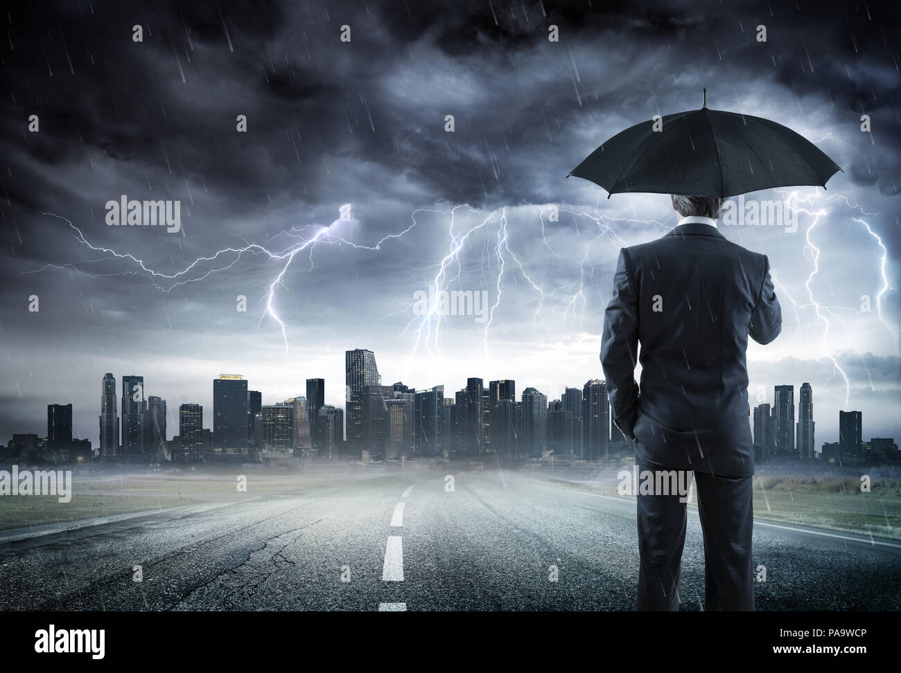 Geschäftsmann mit Regenschirm suchen Sturm über die Stadt Stockfoto