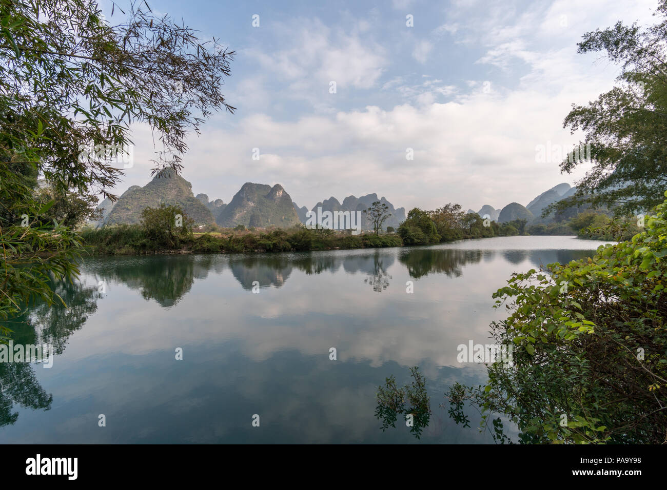 Panoramablick auf die grünen Berge in noch Wasser wider. Yangshou, China Stockfoto