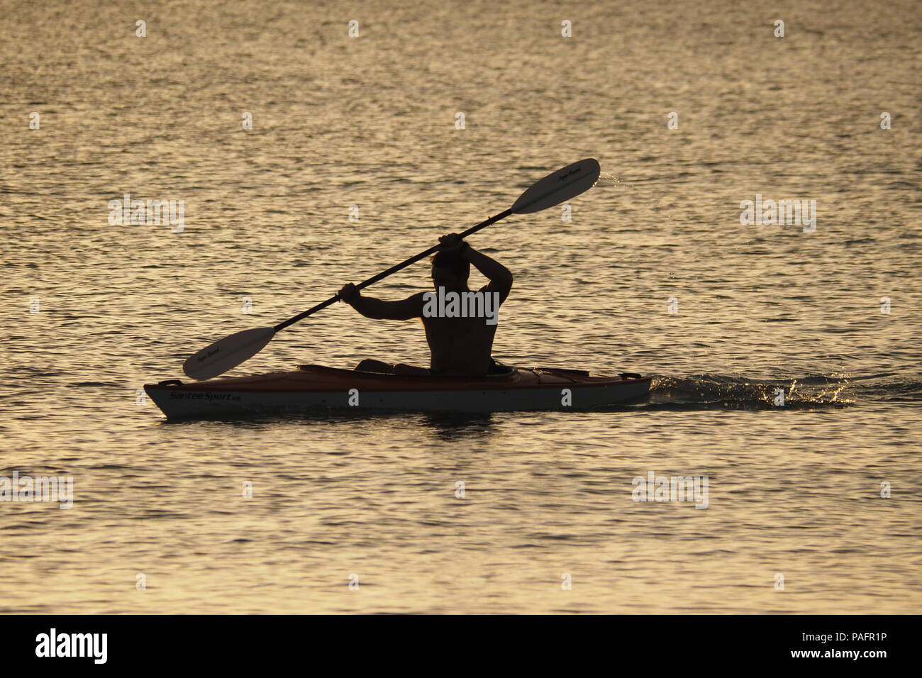 Junge Mann in teilweiser Silhouette aus Kajak Captiva Island, Florida, Usa. Stockfoto