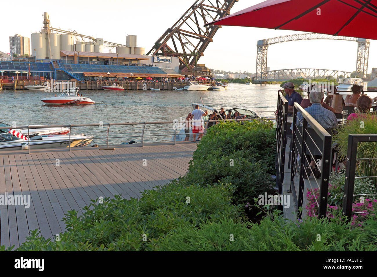 Essen im Freien entlang der Cuyahoga River in Cleveland, Ohio, USA ist ein Sommer Tradition Menschen zum flußufer Flats Entertainmentviertel. Stockfoto