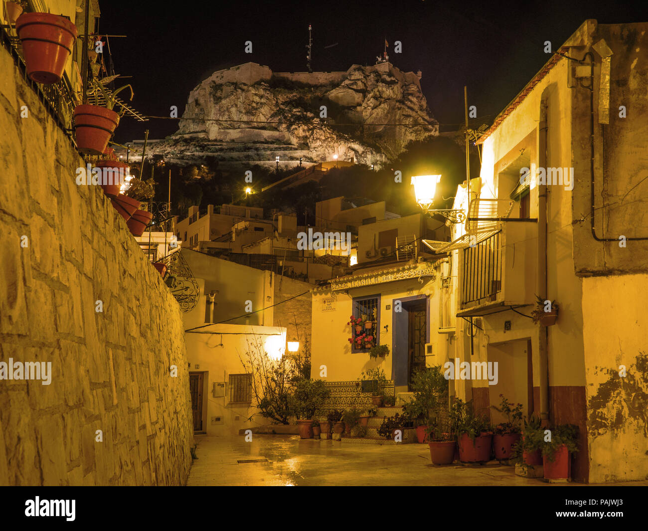 Schwaches Licht der Straßenlaternen beleuchtet die schlafenden Stadt, Alicante. Spanien Stockfoto