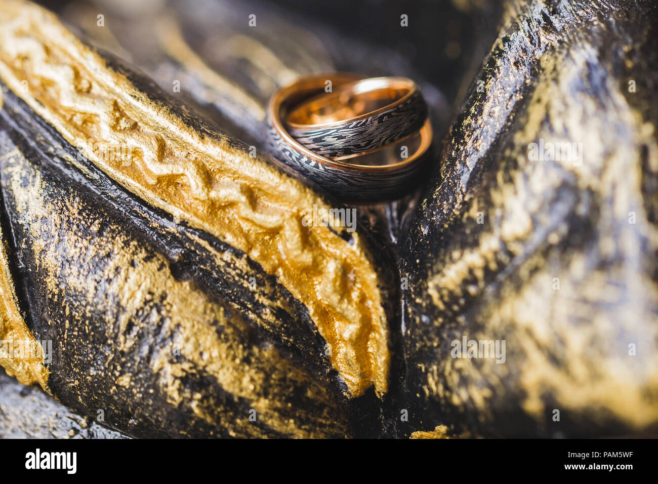 Zwei Schwarz Und Gold Trauringe Auf Stein Gemalt Multicolor Hintergrund Stockfotografie Alamy