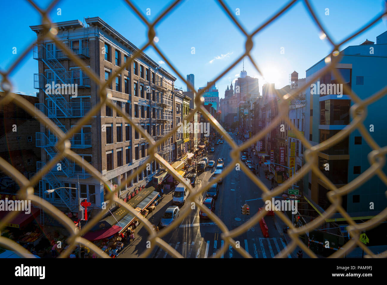 NEW YORK - ca. August 2017: Downtown Manhattan und Chinatown durch eine chainlink Fence auf der Manhattan Bridge gesehen. Stockfoto