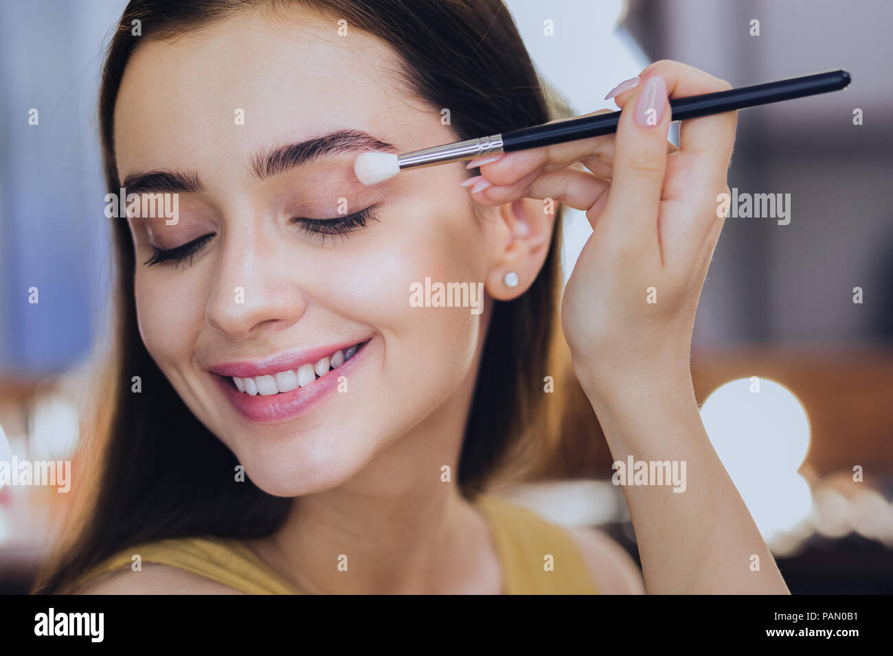Angenehmes Lächeln make-up-artist Abschluss ihres Alltags Make-up Stockfoto