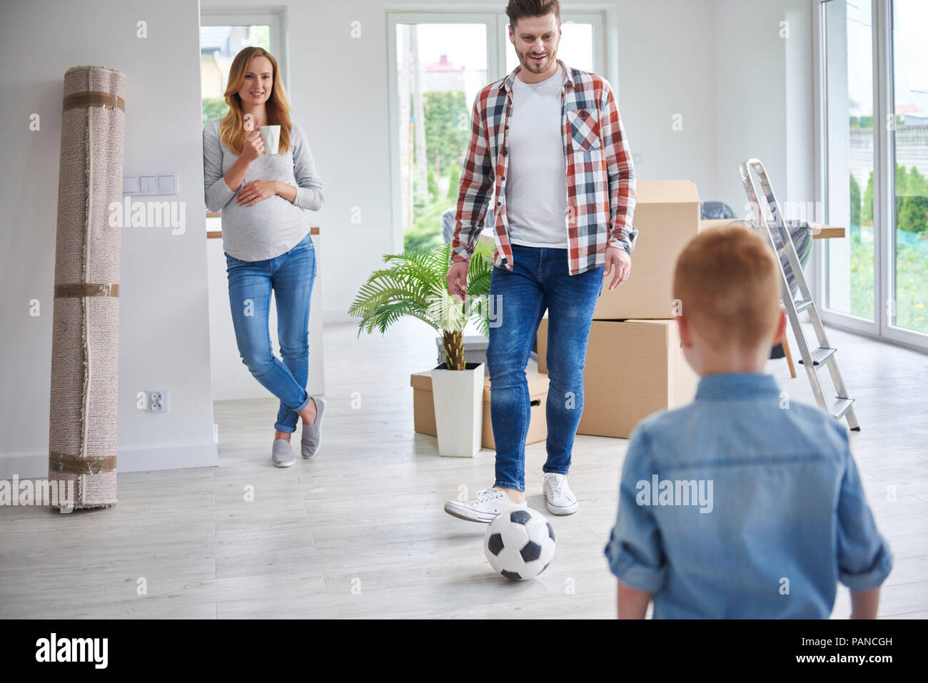 Familie Fußball spielen in der neuen Wohnung Stockfoto