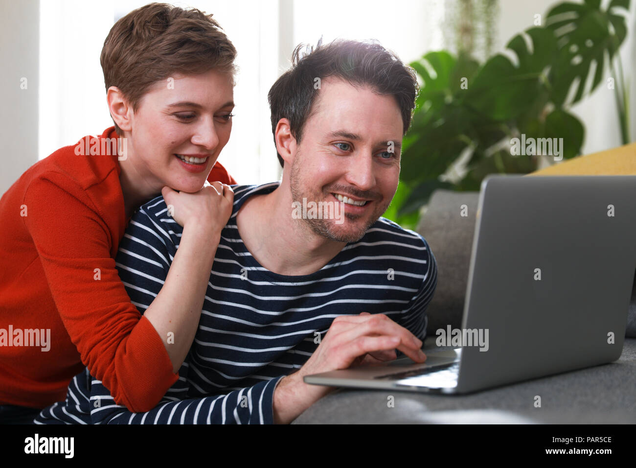 Paar, zu Hause zu sitzen, mit Laptop Stockfoto