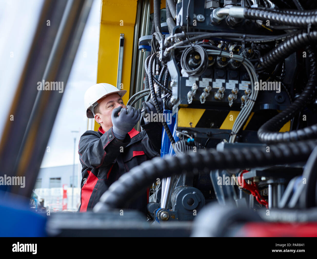 Arbeitnehmer zur Festsetzung der Schlauchleitung mit Schraubenschlüssel Stockfoto