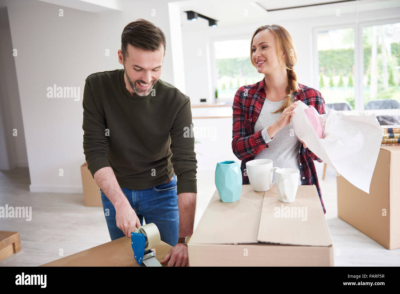 Paar Umzug packen und taping Kartons Stockfoto