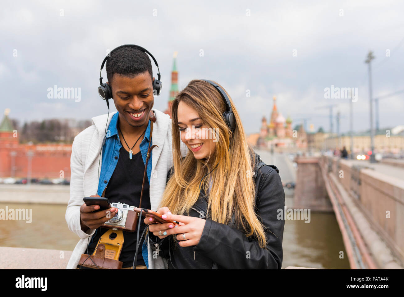 Russland, Moskau, Multirassischen beste Freunde Musik hören mit Kopfhörern Stockfoto