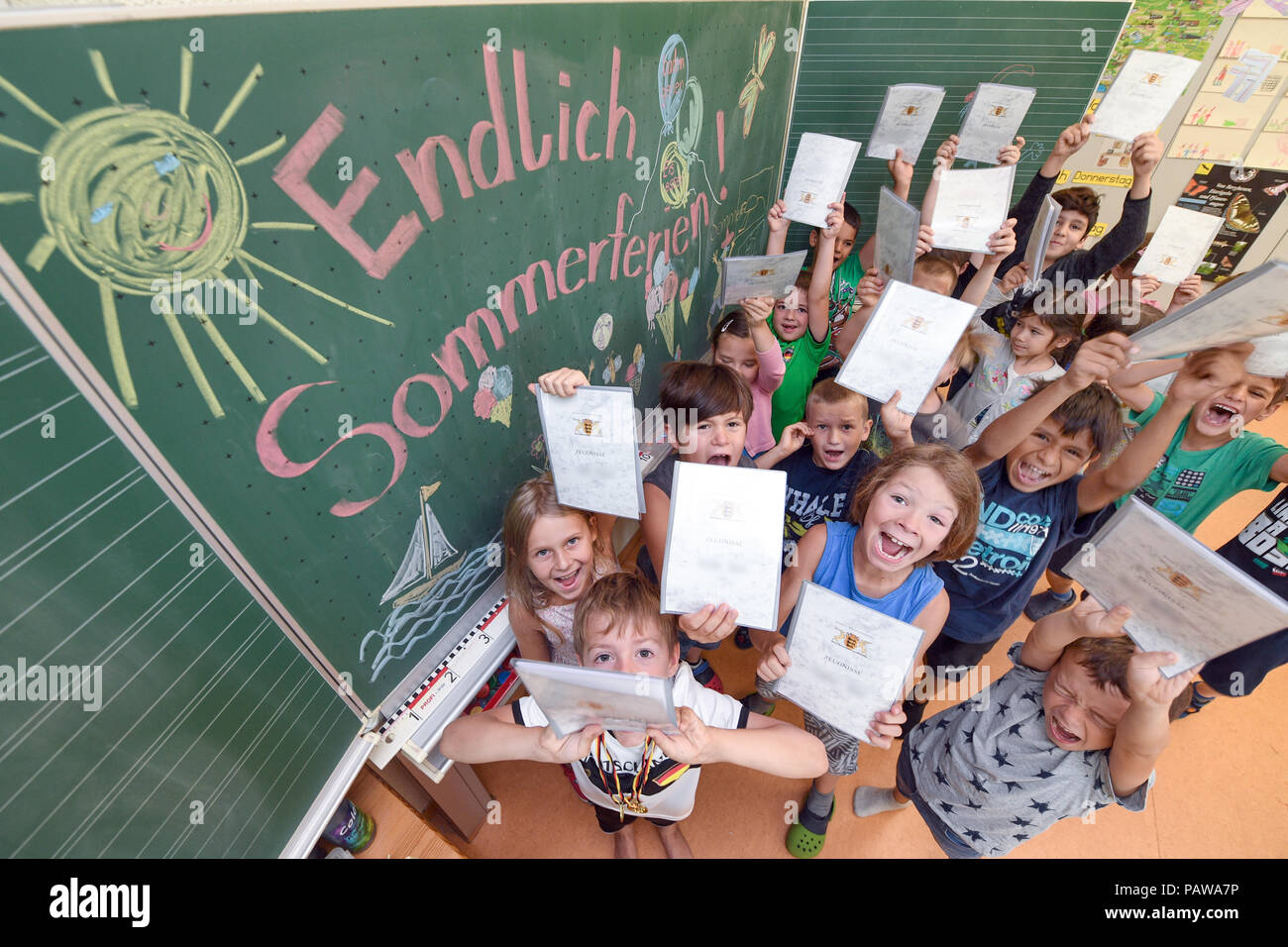 25. Juli 2018, Weißenau, Deutschland: Erstklässler der Grundschule in weißenau stehen an der Tafel mit ihrer Zertifikate, auf dem es heißt: "Endlich Sommerferien". Foto: Felix Kästle/dpa - ACHTUNG: Die Namen der Kinder wurde aus rechtlichen Gründen in den Zeugnissen unkenntlich gemacht. Stockfoto