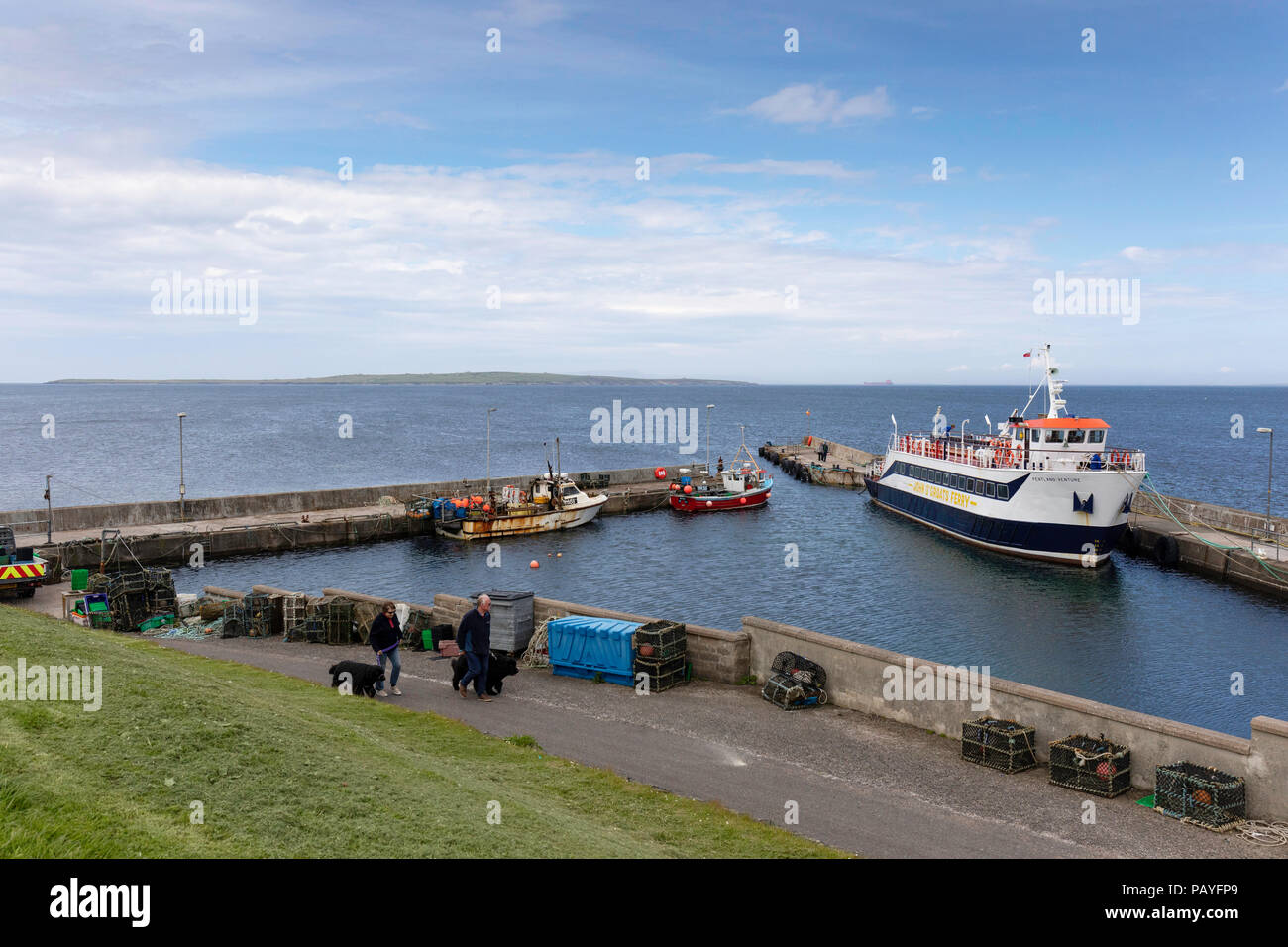 Fähre und Hafen mit Orkeney im Hintergrund bei John O' Groats Stockfoto