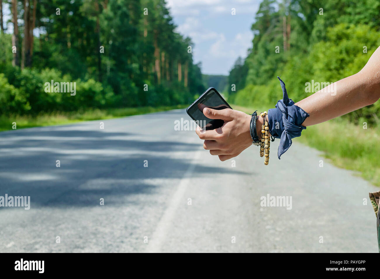 Teenager mit Smartphone per Anhalter für Travel Concept. Nahaufnahme Stockfoto