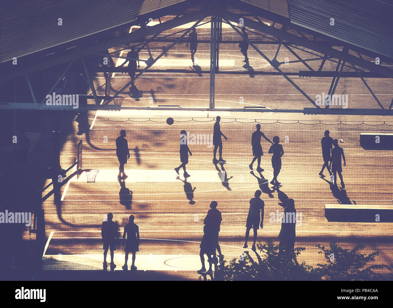 Basketball spieler Silhouetten auf Brooklyn pier Hof bei Sonnenuntergang, Farbe Tonen angewendet, New York City, USA. Stockfoto