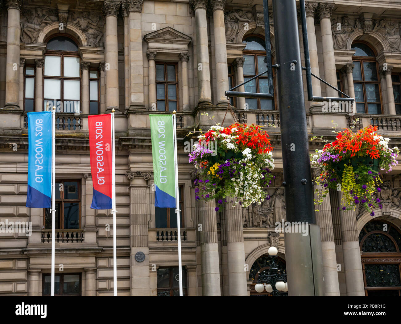 Glasgow, UK. 27. Juli 2018. Glasgow Em-Vorbereitungen, den 27. Juli 2018. Glasgow und Berlin Gastgeber der Eröffnungs-Europameisterschaften Sport Event mit führenden Sportarten wie Leichtathletik, Wassersport, Radfahren, Turnen, Rudern, Triathlon mit einem neuen-Meisterschaften. Die Spiele werden alle vier Jahre ausgetragen werden ab 12. August 2018. Große bunte Banner Werbung für die Spiele außerhalb von Glasgow City Chambers mit blumenkörben eingerichtet Stockfoto