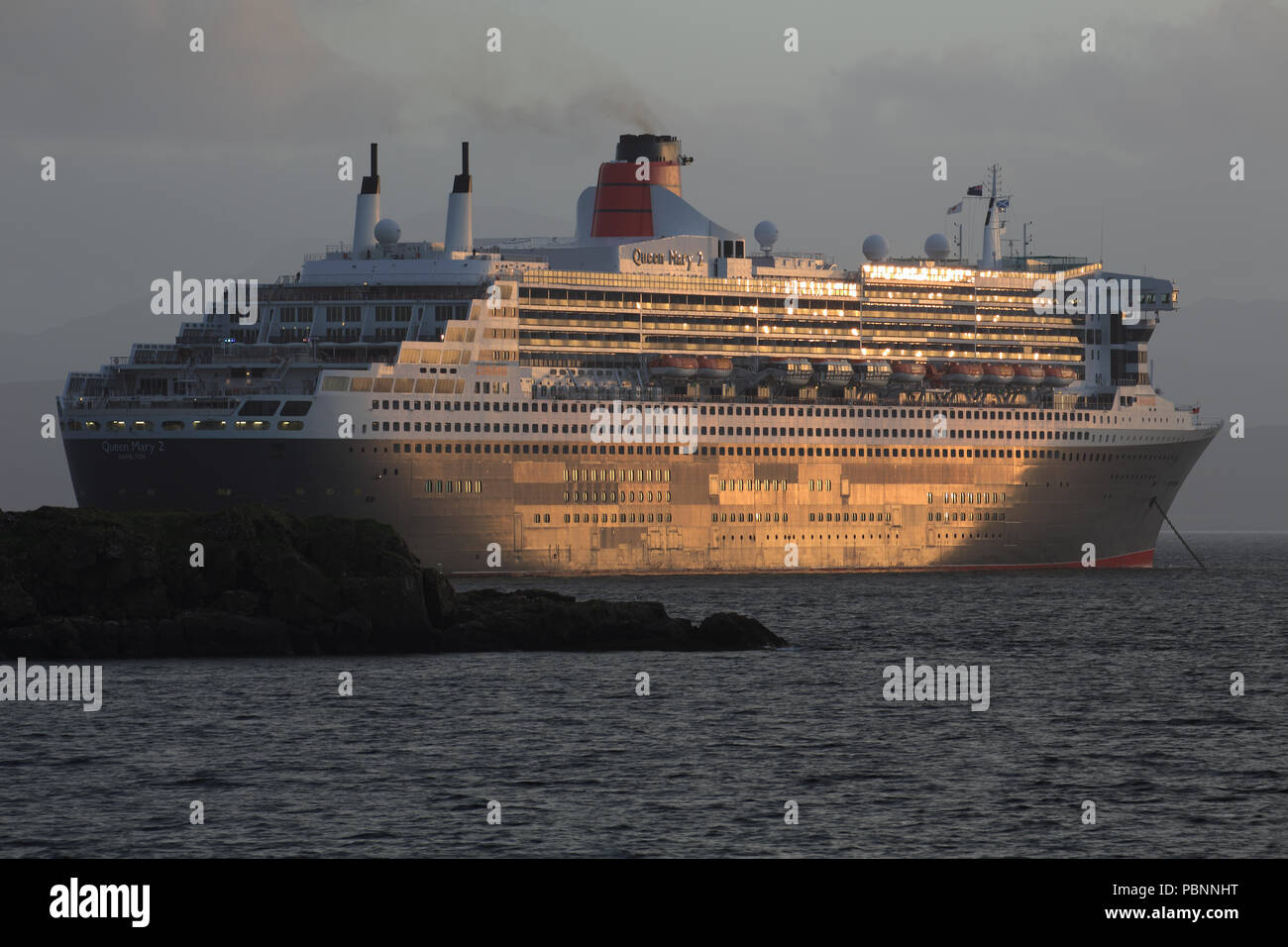 RMS Queen Mary 2 bei Sonnenuntergang Stockfoto