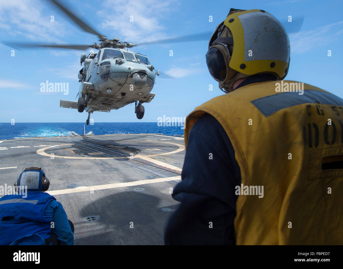 180720-N-JAHRE 245-0047 PAZIFISCHEN OZEAN (Juli 20, 2018) Eine MH-60S Hubschrauber, die "Schwarzen Ritter" der Hubschrauber Meer Combat Squadron (HSC) 4, landet auf dem Flugdeck der geführten-missile Cruiser USS Lake Champlain (CG57) während einer Auffüllung-auf-See aus dem Zusatzkreis Dry Cargo und Munition ship USNS Charles Drew (T-AKE 10) für Rim der Pazifik (Rimpac) Übung, Juli 20 zugeordnet. 25 Nationen, 46 Schiffe und fünf U-Boote, und etwa 200 Flugzeugen und 25.000 Mitarbeiter sind teilnehmenden RIMPAC vom 27. Juni bis 2. August in und um die hawaiischen Inseln und Südkalifornien. Der Welt l Stockfoto