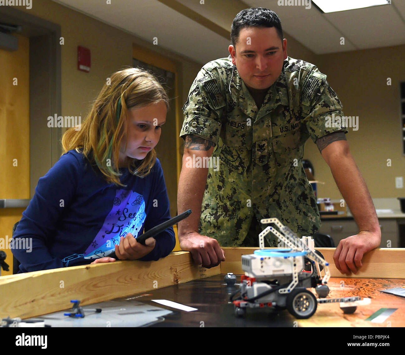 Bau Elektriker 2. Klasse Benjamin Phelps, zum Navy Operational Support Center (Nosc) Fargo zugeordnet ist, unterstützt ein Student Program ihr Roboter an der Minnesota State University Moorhead Hochschule für Kinder Sommer Camp in Fargo - Moorhead Metro Marine Woche. Die Marine von Community Outreach verwendet die Navy Woche Programm Navy Sailors, Ausrüstung mitbringen und zeigt auf etwa 14 amerikanischen Städten jedes Jahr für eine Woche - lange Zeitplan von outreach Engagements für Amerikaner ausgelegt, aus erster Hand, wie die US-Marine ist die Marine die Nation braucht Erfahrung. (U.S. Marine Foto von Massenkommunikation Spec Stockfoto