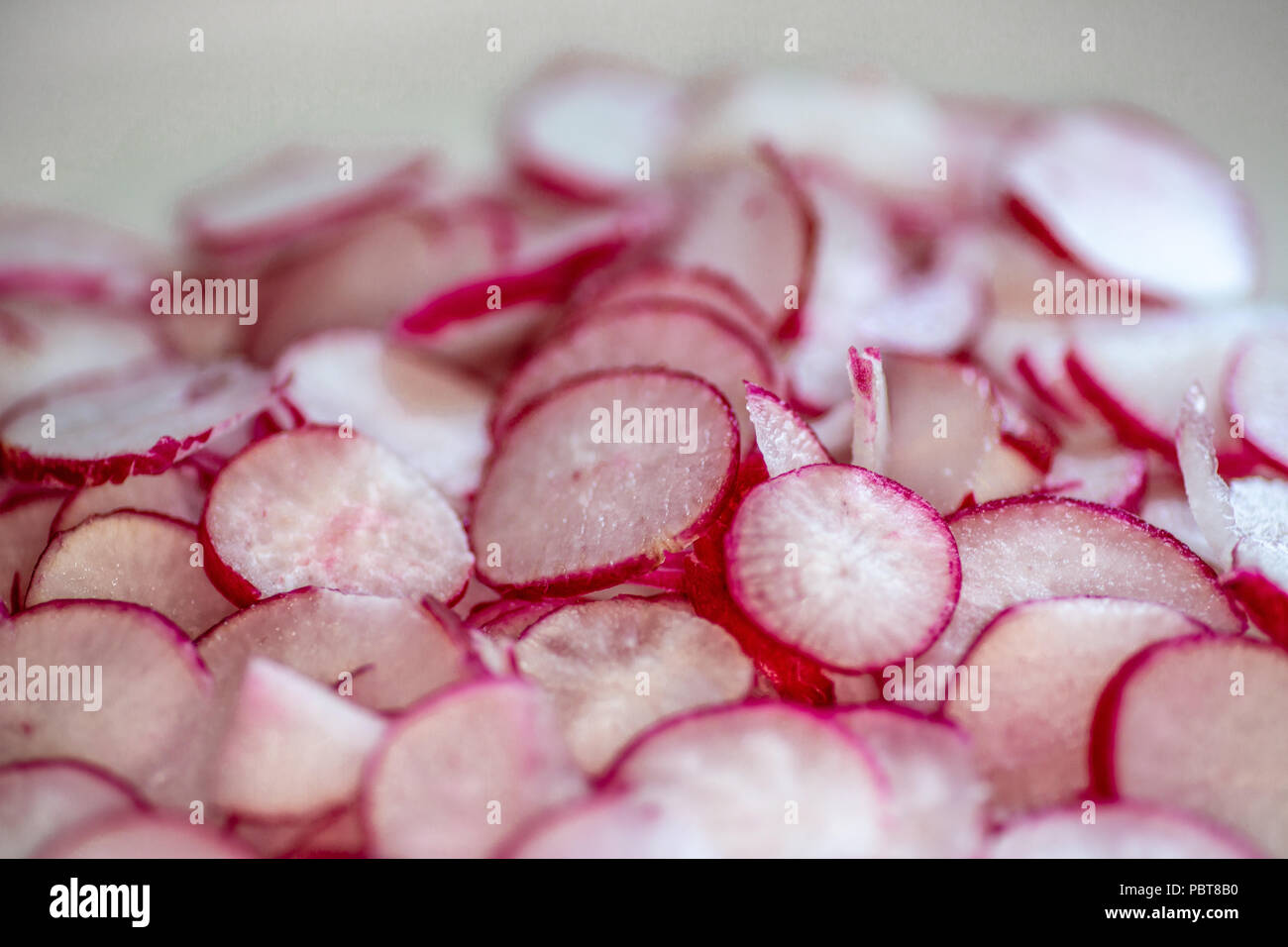 Platte voll von frisch geschnittenen Radieschen auf der Arbeitsplatte in der Küche warten auf den Küchenchef in einem Rezept zu verwenden. Stockfoto