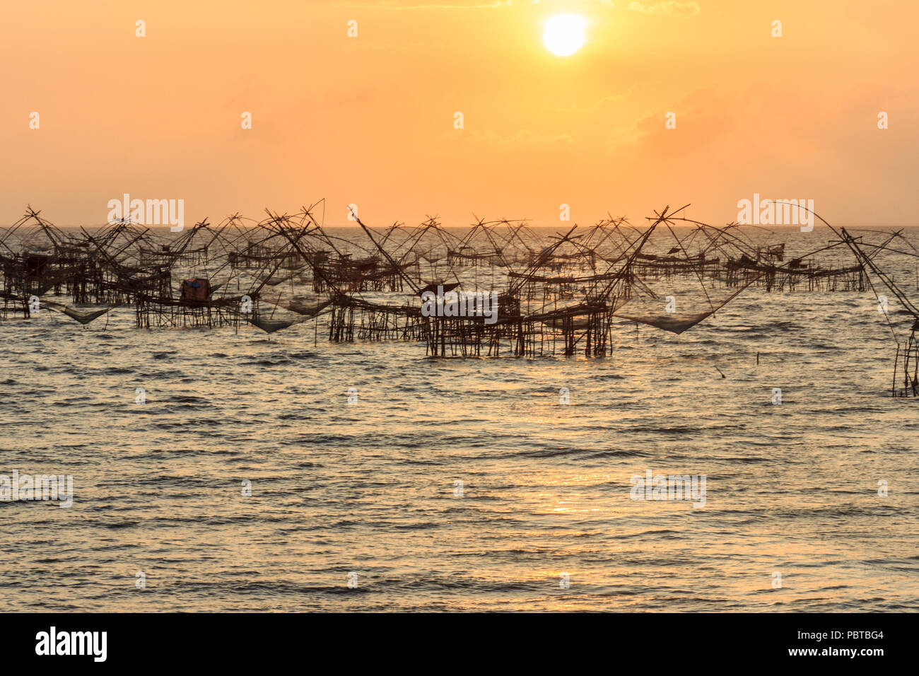 Sonnenaufgang über Fischernetze, Songkhla See, Thailand Stockfoto