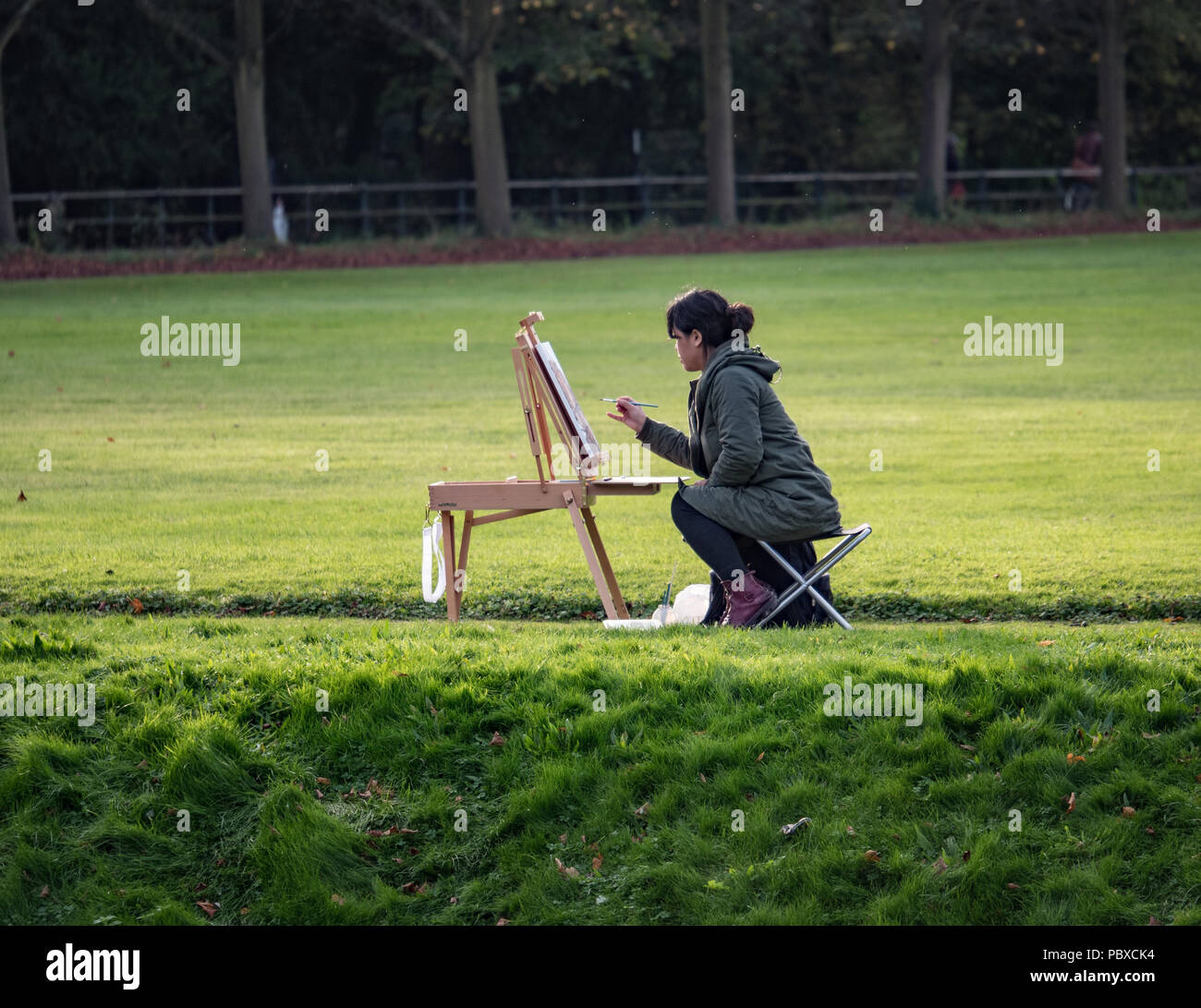 Ein Künstler Malerei eine Landschaft Szene auf dem Gelände des Trinity College Cambridge England UK. Stockfoto