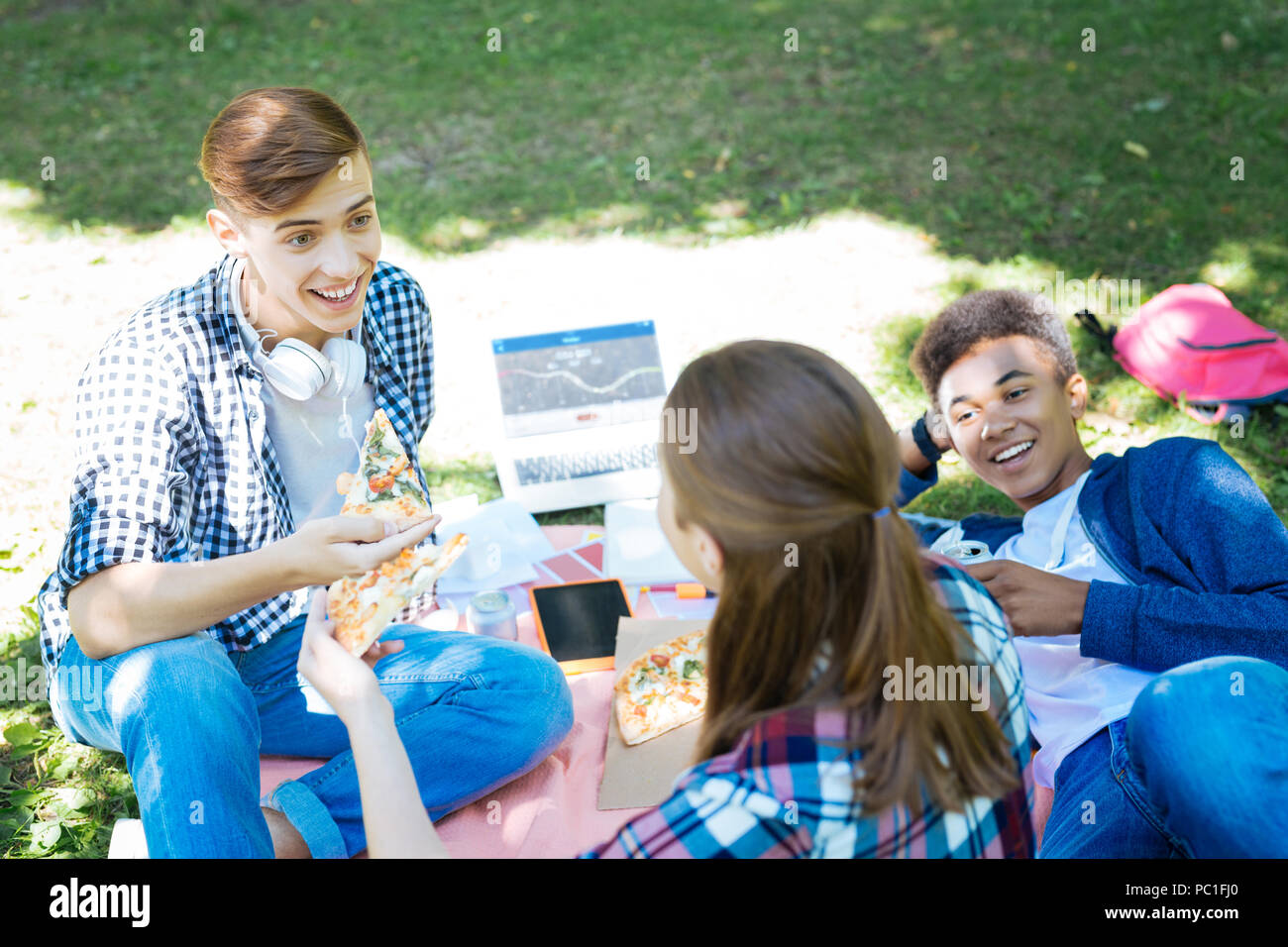 Drei aktive Studenten, pizza Pause während der Arbeit am Projekt Stockfoto