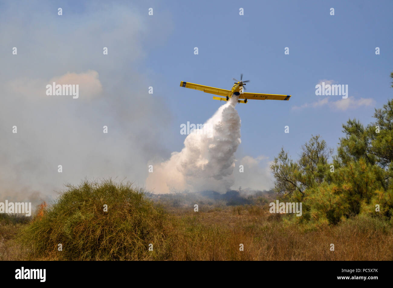 Flugzeuge Tropfen Wasser in ein Feuer durch palästinensische Kite Bomben, die von Gaza mit einer beleuchteten Benzin getränkte Lappen geflogen wurden, um Brände zu israelischen fiel zu setzen Stockfoto
