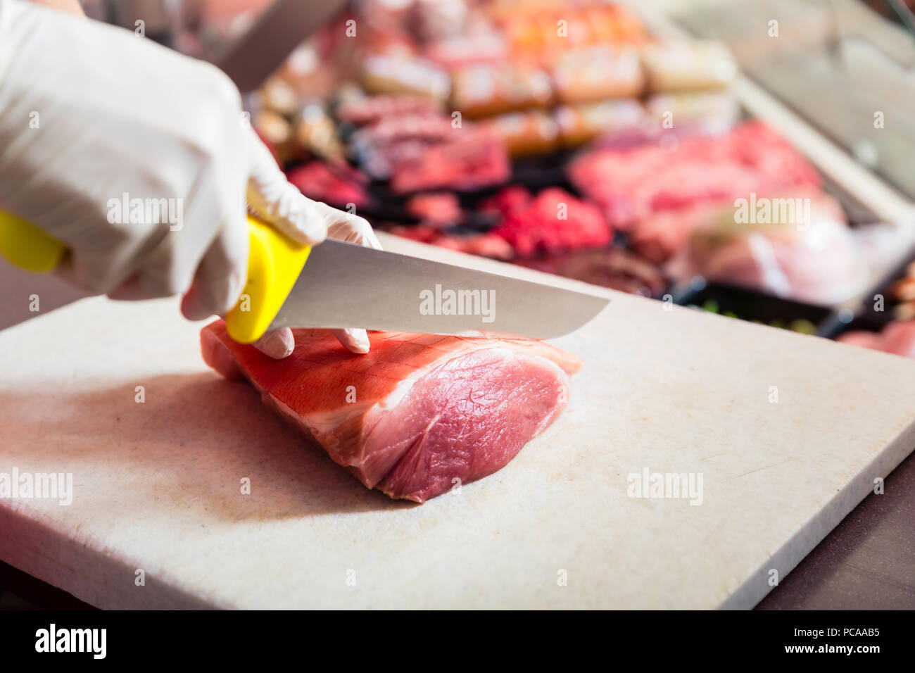 Frau in Metzgerei verkaufen Fleisch Filet Stockfoto