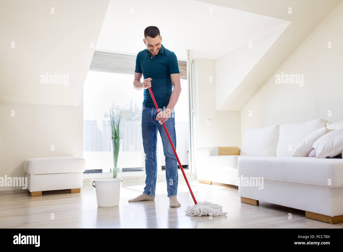 Mann mit Wischmopp und Eimer Reinigung Boden zu Hause Stockfoto
