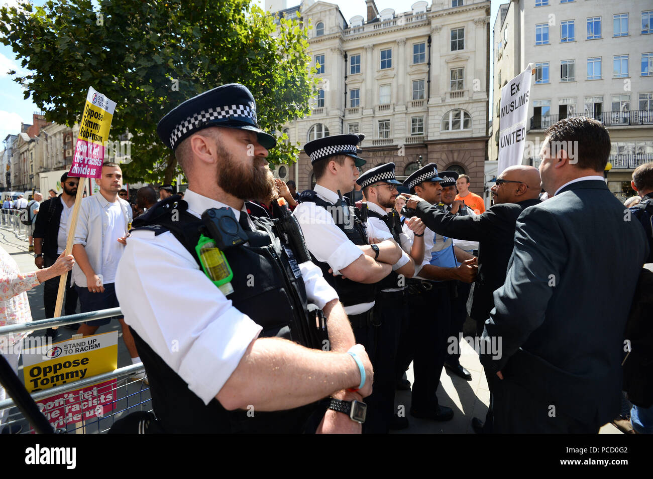 Polizei in zwischen Demonstranten außerhalb der Royal Courts of Justice in London, wo die ehemalige English Defence League (EDL) leader Tommy Robinson auf Kaution durch das Berufungsgericht, nachdem er eine Herausforderung gegen die Feststellung der Missachtung des Gerichts freigegeben wurde. Stockfoto