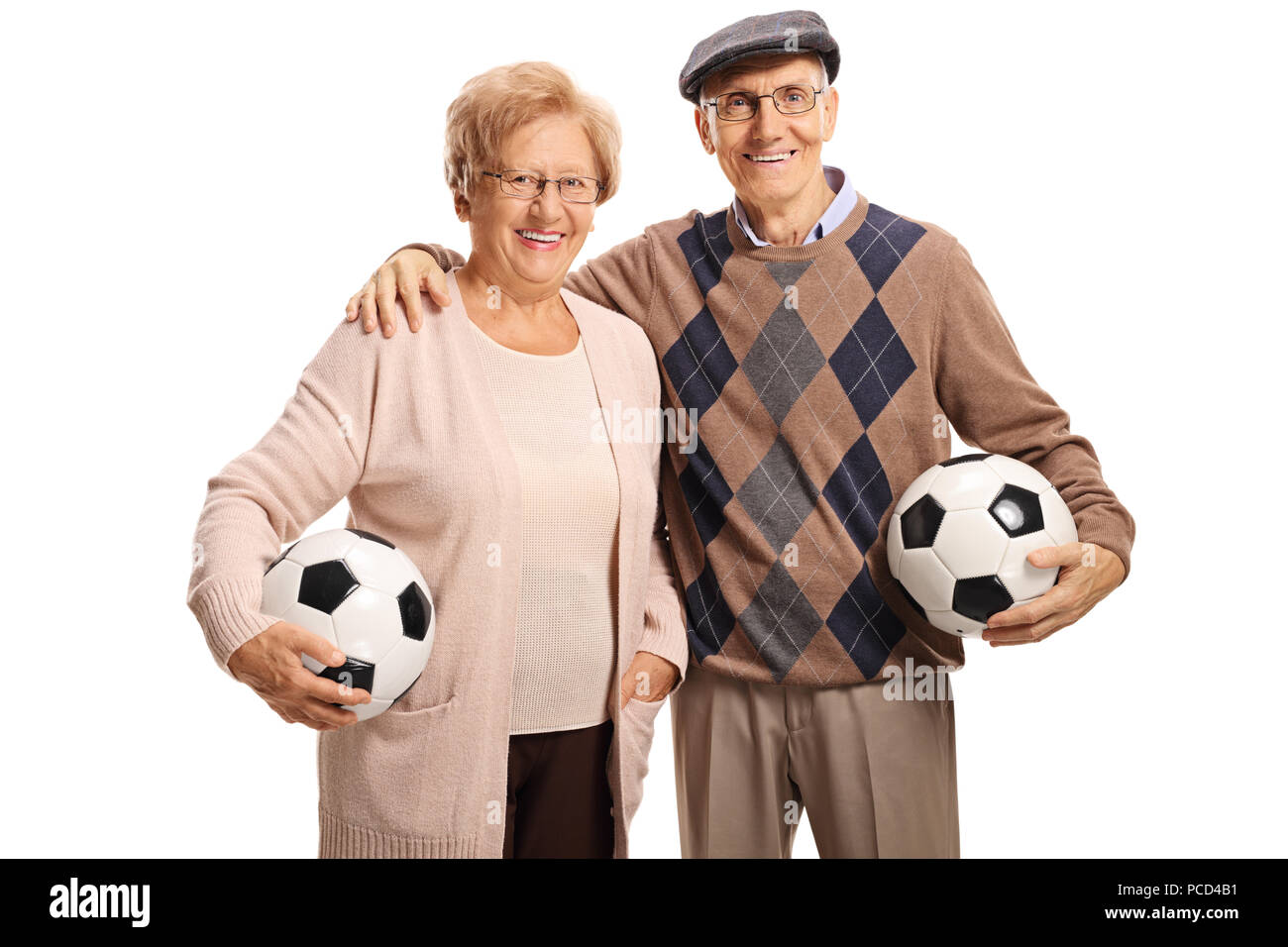 Senior Paar mit Fußbällen in die Kamera schaut und lächelnd auf weißem Hintergrund Stockfoto