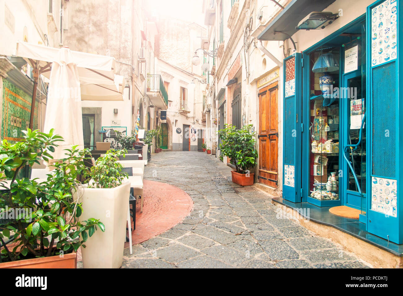- VIETRI SUL MARE, Italien - 3 September, 2017: Blick auf leere schmale Straße voller Cafés und Souvenirläden am frühen Morgen mit der Sonne durch die Stockfoto