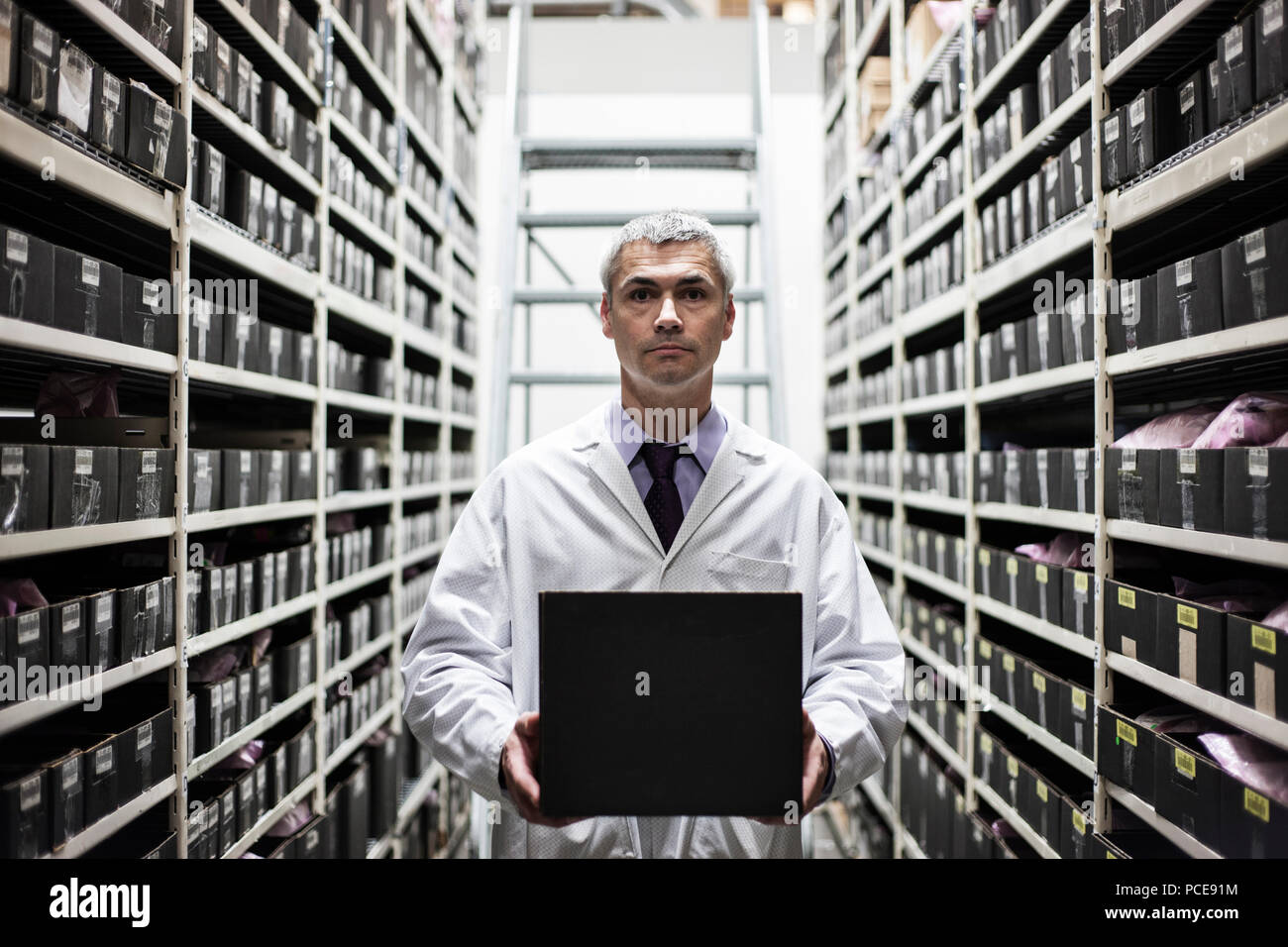 Ein Kaukasier Männlich Techniker arbeitet an einem Laptop Computer in einem teile Gang in der technischen Forschung und Entwicklung. Stockfoto