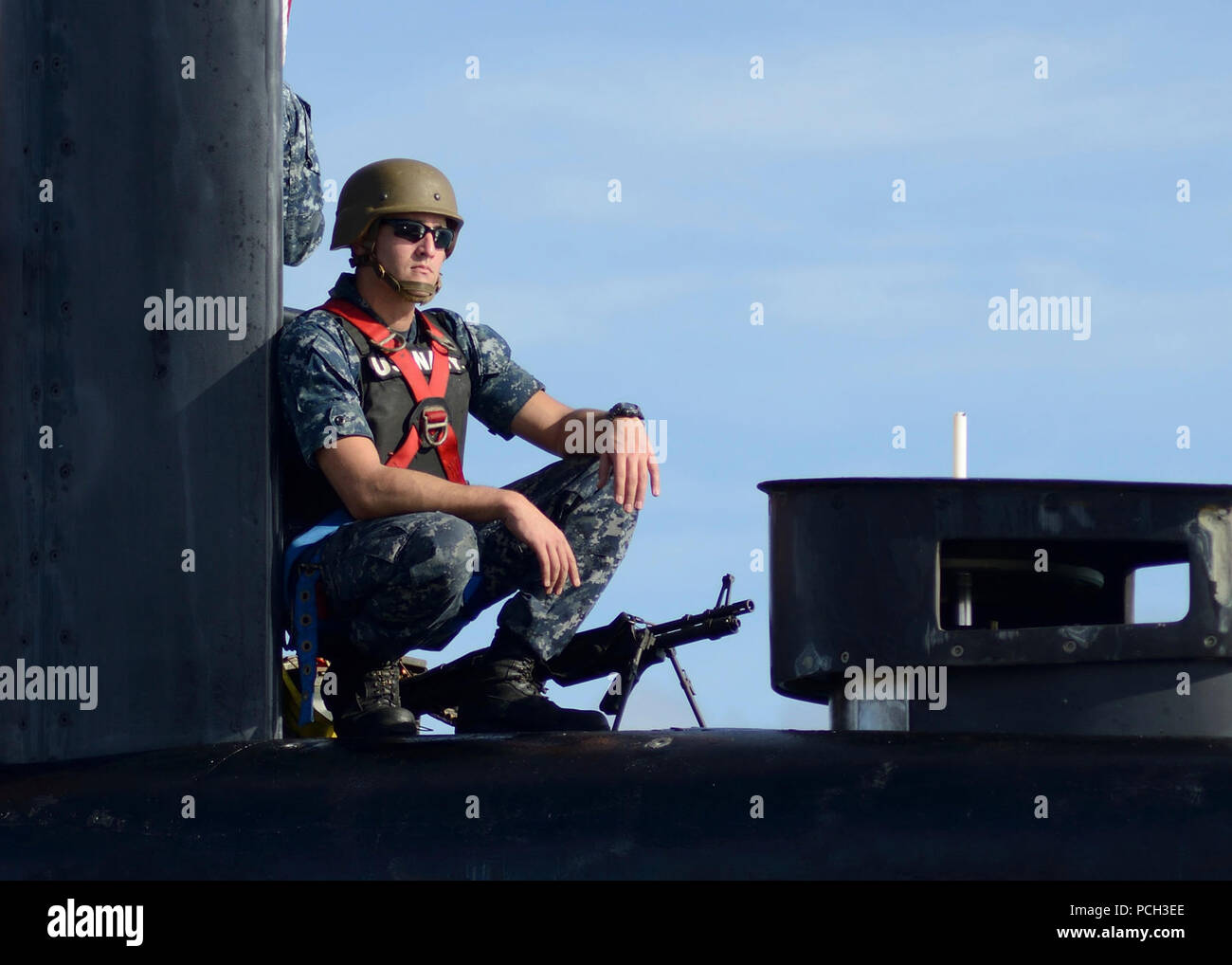 DIEGO GARCIA (31. 4, 2013) Fire-Techniker 2. Klasse Nathan Bownas, zu den Los Angeles-Klasse schneller Angriff U-Boot USS Scranton (SSN 756), bietet Sicherheit für das Boot, als es in der US-Marine Support Facility Diego Garcia zieht. Stockfoto