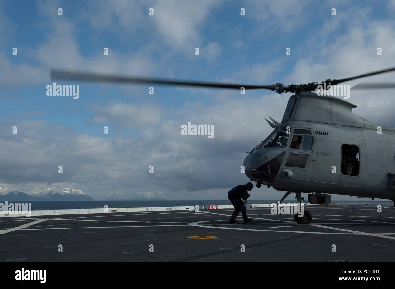 COOK Inlet, Alaska (April 30, 2013) eine Abteilung Matrosen mit Unterlegkeilen sichern und die Kette ein Marine Corps CH-46 Sea Knight Helikopter in das Deck als San Antonio-Klasse amphibious Transport dock Schiff Pre-Commissioning Steuergerät (PCU) Anchorage (LPD 23) nähert sich der Küste von Alaska. Anchorage ist auf dem Weg zu seinem Namensvetter Stadt Anchorage, Alaska, für seine Inbetriebnahme Zeremonie Mai 4. Stockfoto