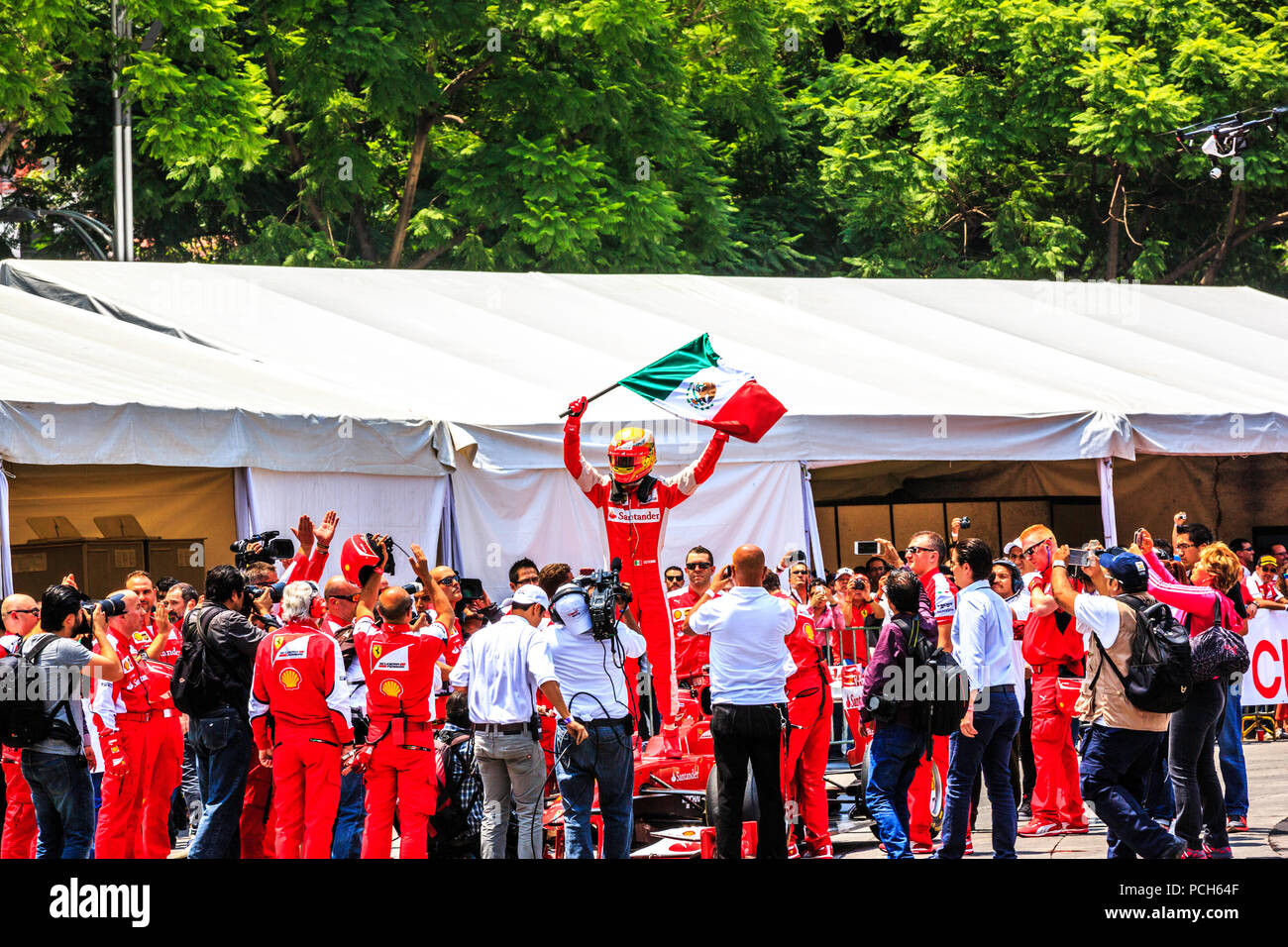 Mexiko City, Mexiko - 08 Juli, 2015: Esteban Gutiérrez Winken der Mexikanischen Flagge nach der dritten Runde beendete mit seinem Ferrari F1 F60 Auto. Bei der Scuderia Ferrari Straße Demo von Telcel - ad infinitum. Stockfoto