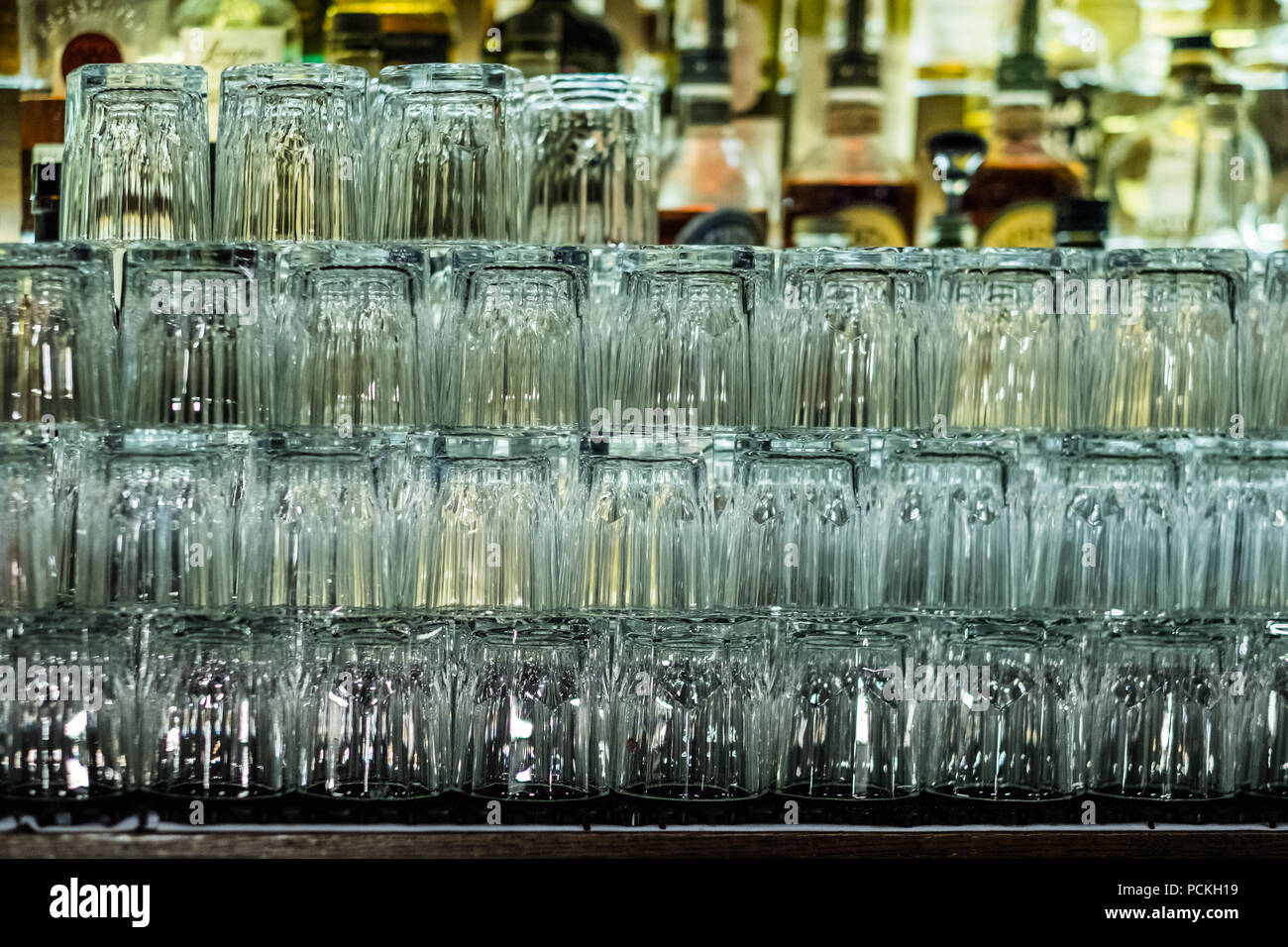 Leere Gläser auf Bar Inneneinrichtung Hintergrund. Künstliche Beleuchtung erzeugt Reflexionen und starrt in Glas. Zusammenfassung Hintergrund. Kopieren Sie Platz. Stockfoto