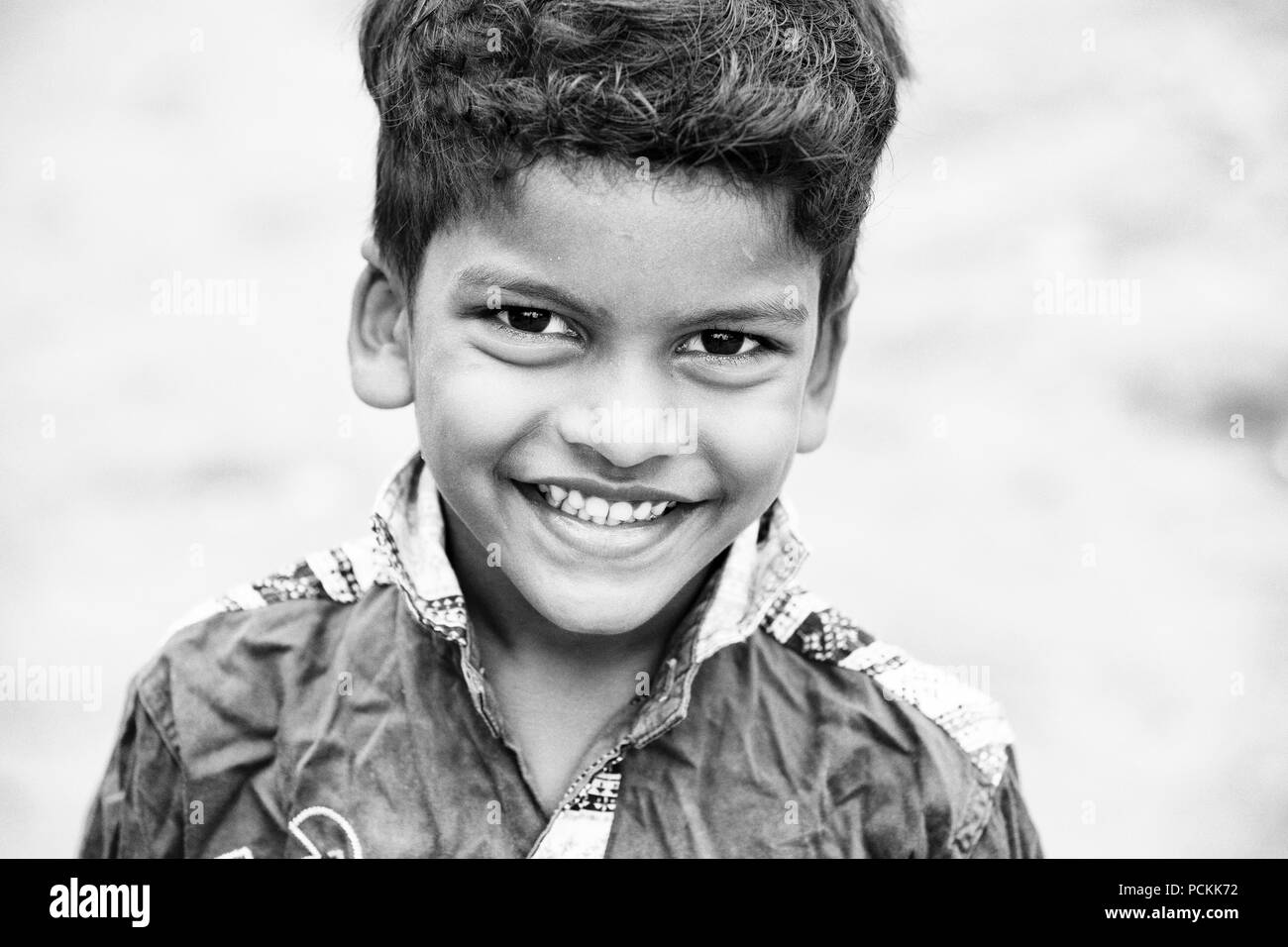 PONDICHERY, PUDUCHERRY, Tamil Nadu, Indien - SEPTEMBER CIRCA, 2017. Portrait von unbekannten indischen armes Kind Junge lächelt draußen auf der Straße. Blac Stockfoto